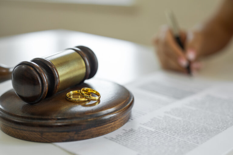Rings on top of a gavel and mallet to represent a divorce order