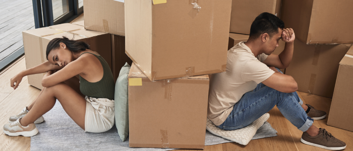 Divorced couple fighting while moving out