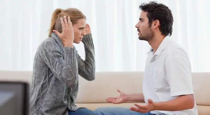 A couple argues intensely, one person looking surprised and confused, the epitome of being blindsided by divorce.