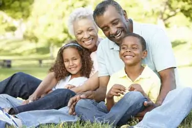 Parents sit with their child and legal papers in a lawyer's office, discussing the details of a Joint Managing Conservatorship arrangement.