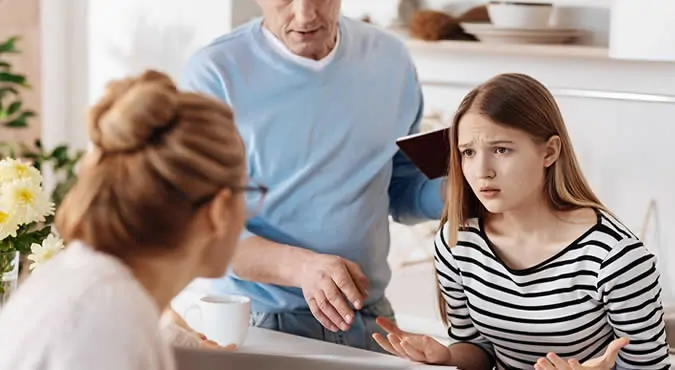 Parents sit with their child and legal papers in a lawyer's office, discussing the details of a Joint Managing Conservatorship arrangement.