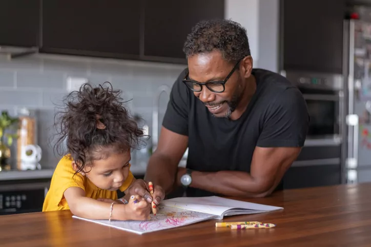 A parent and child joyfully playing together, symbolizing the collaborative spirit of parents working together on their parenting approaches.