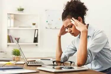 A person sits alone, looking tired and sad amidst coping with divorce, embodying the deep need for emotional support from friends.