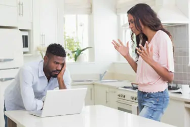 A couple arguing over social media use, highlighting the strain it can place on relationships.