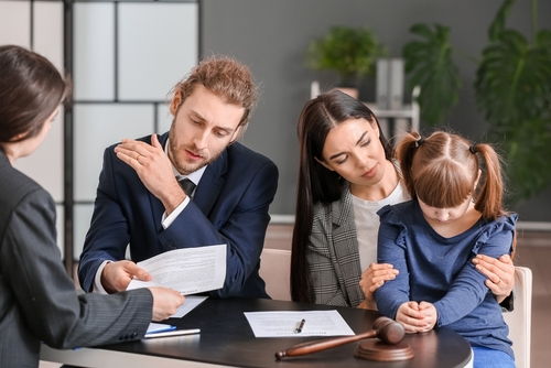 A family consults with a family lawyer, symbolizing their journey to understanding the nuances of Family Law Order Enforcement in Austin.