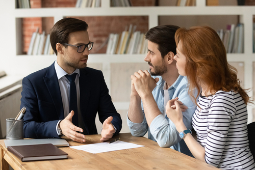 Couple discussing prenuptial agreement with a lawyer