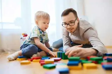 A father and son enjoy playing together, capturing a cherished moment of a child spending quality time with a parent.