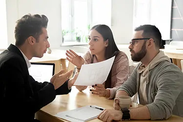 A couple argues in a law office, their tense exchange highlighting the complexities and entitlements related to spousal support in divorce proceedings.