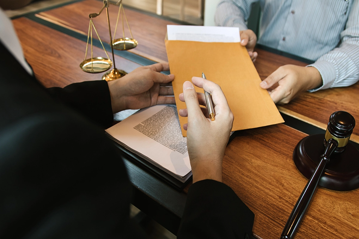 family law order modificaiton lawyer handing document to someone