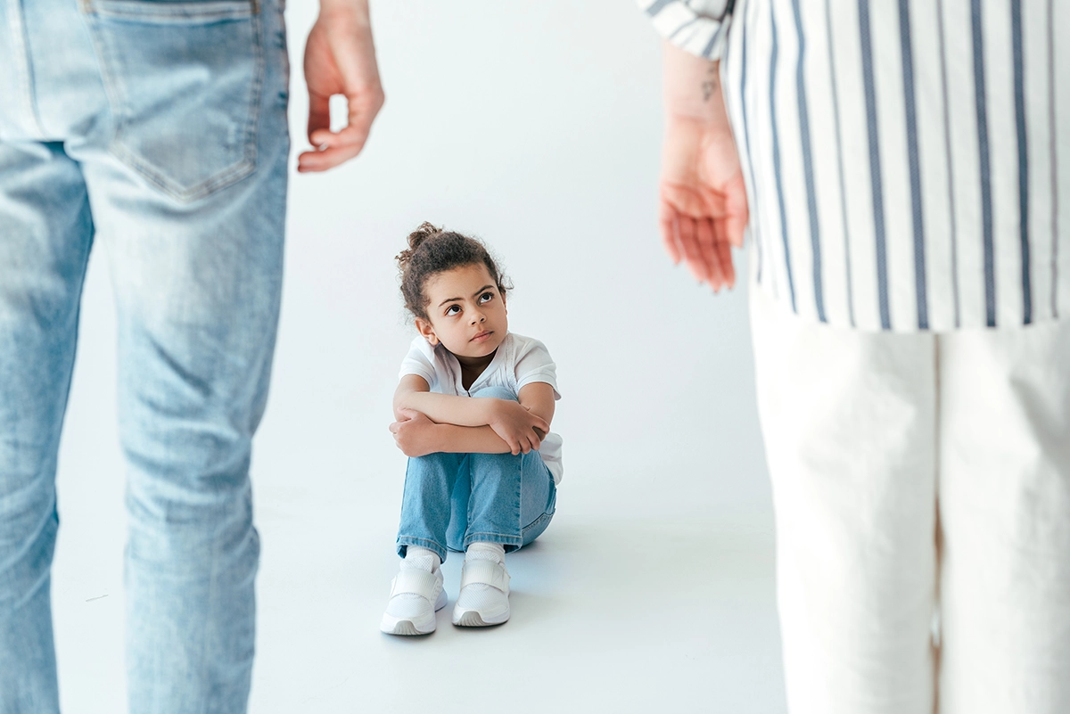 selective focus of african american kid sitting ne 2024 11 08 19 50 11 utc child sitting between parents and looking up at them