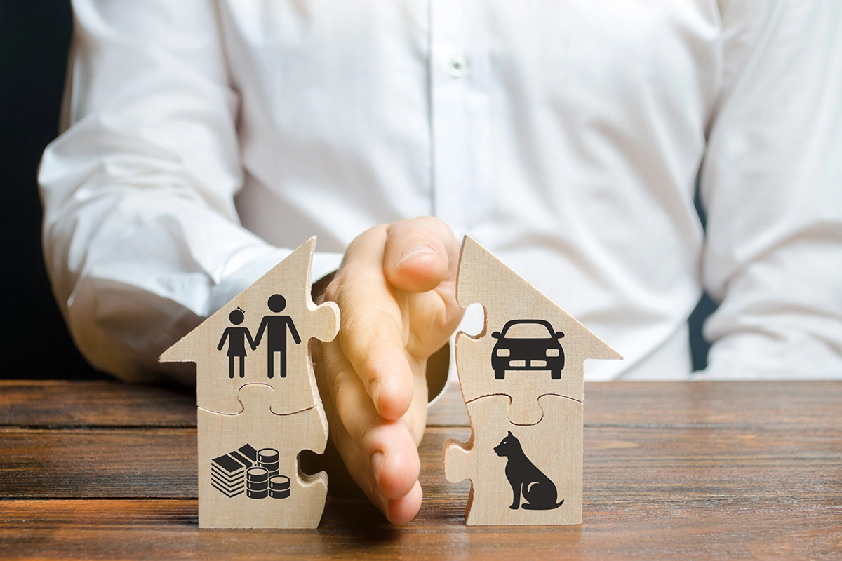 man splitting house model with his hand man splitting house model with his hand