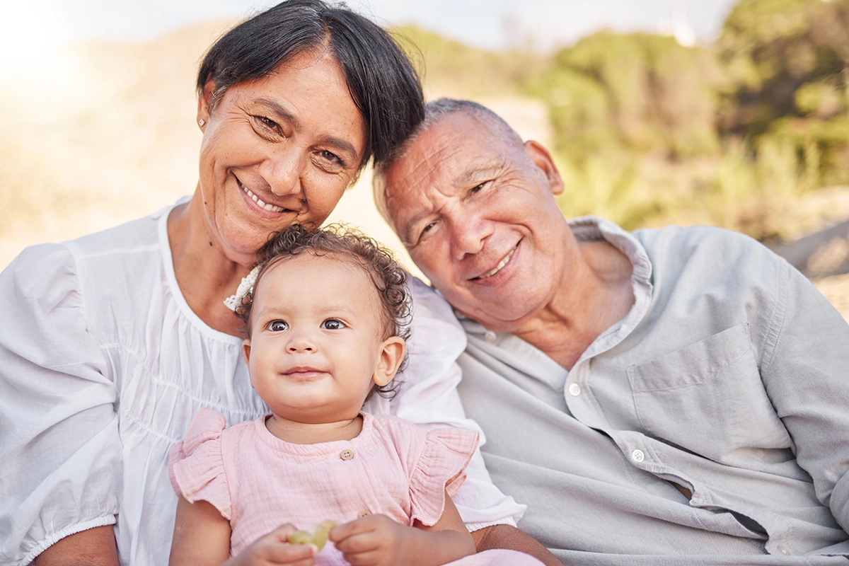 smiling grandparents with baby resized smiling grandparents with baby